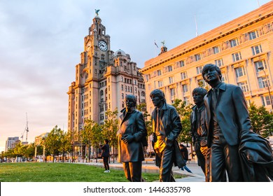 LIVERPOOL, ENGLAND - MAY 18, 2019 : Bronze statue of the Beatles; stand on Liverpool’s Pier Head waterfront on the side of River Mersey, sculpted by Andrew Edwards, photo shooting in the evening.