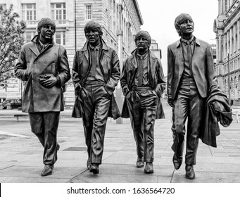 Liverpool, England - May 28, 2017: Bronze Statues of The Beatles located on Pier Head, They were created by Andy Edwards and unveiled in December 2015 