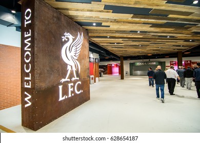 Liverpool / England - September 12, 2016 : Tourists walking pass the welcome board inside the Anfield Stadium.