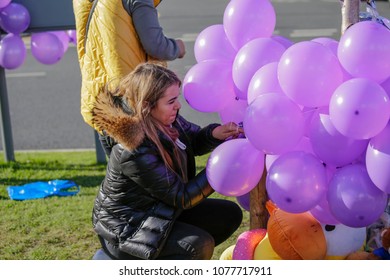 LIVERPOOL, MERSEYSIDE United Kingdom – APRIL 25 2018: Supporter Leaving Purple Balloons At A Shrine For Alfie Evans Outside Alder Hay Hospital