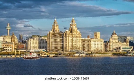 Liverpool Skyline St Johns Tower  Cathedral.. The Three Graces the Royal Liver Building. The Cunard Building.  former offices of the Mersey Docks and Harbour Board. Royal Iris Ferry across the Mersey.