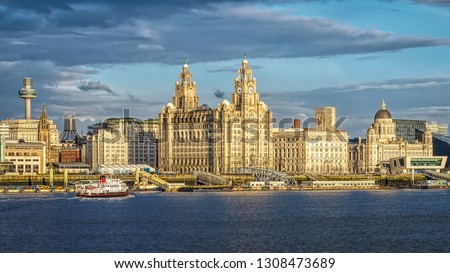Liverpool Skyline St Johns Tower  Cathedral.. The Three Graces the Royal Liver Building. The Cunard Building.  former offices of the Mersey Docks and Harbour Board. Royal Iris Ferry across the Mersey.