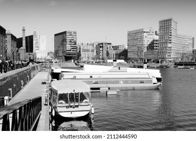 LIVERPOOL, UK - APRIL 20, 2013: People visit the docks in Liverpool, UK. Famous docks are part of Liverpool's UNESCO World Heritage Site, a notable tourism destination.