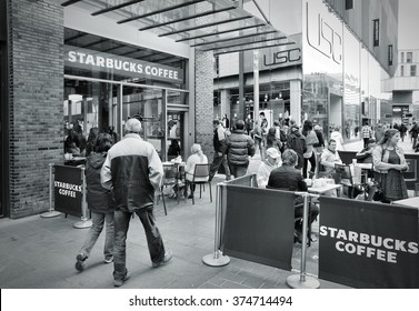 LIVERPOOL, UK - APRIL 20, 2013: People visit Starbucks Coffee in Liverpool, UK. Starbucks is the largest coffee house company in the world, it has 20,891 stores in 62 countries.