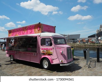 Liverpool, UK - June 22 2019: A Summer View Of Liverpool Waterfront, Albert Dock. Pink Food Truck Selling Donuts And Waffles.