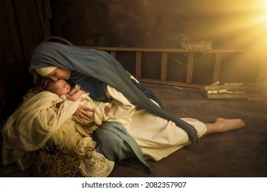 Living Christmas Nativity Scene of parents dressed in authentic clothes, with their 9 days old baby boy in swaddles - Shutterstock ID 2082357907