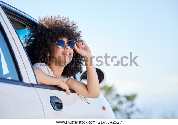 Living the dream. Shot of a beautiful
young woman enjoying an adventurous ride in a
car.