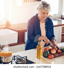 Living And Eating Healthy. Cropped Shot Of A Senior Woman Cooking In Her Kitchen.