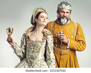 Living The Lavish Royal Life. Studio Shot Of A King And Queen Drinking Out Of Goblets.