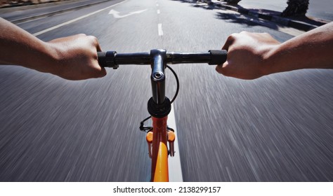 Living life behind bars. POV shot of a person riding a bicycle along a road.
