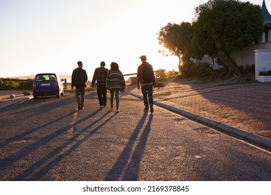 Living In The Moment. Rearview Shot Of A Group Of Friends Walking At Sunset.