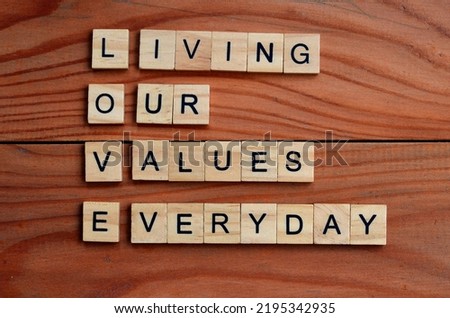 living our values everyday text on wooden square, inspiration and motivation quotes