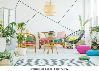 Living Room With Colorful Poufs, Plants And Decorative Tape On The Wall