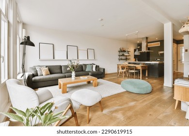 a living room with couches, chairs and a coffee table in the center of the room is large windows - Shutterstock ID 2290619915