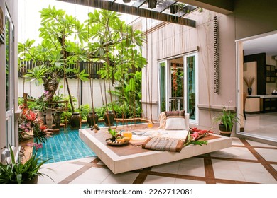 Living room design with modern sofa Fountain and frangipani trees shady Thai style and luxury accessories to decorate your home. selective focus, soft focus. - Shutterstock ID 2262712081