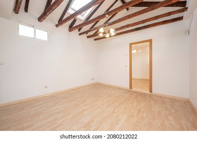 Living room in an empty apartment with exposed wooden beams