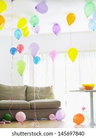 Living Room Full Of Colorful Balloons By Sofa