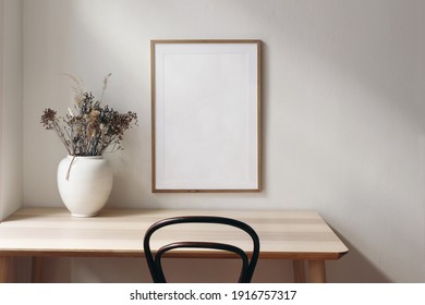 Living Room, Indoor Still Life. Empty Picture Frame Mockup On Wooden Desk, Table And Old Chair. White Vase With Dry Grass. Elegant Working Space, Home Office Concept. Scandinavian Interior Design.