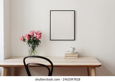 Living Room, Indoor Still Life. Empty Picture Frame Mockup On Beige Wall. Wooden Table And Old Chair. Glass Vase With Pink Peonies Bouquet. Elegant Working Space, Home Office Concept. Interior Design.