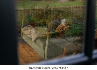 Living room interior cozy home couch soft blankets fireplace hearth wooden mantle objects seen through patio garden glass french doors armchair sofa couch velvet comfy cozy shelves stuff collected - Powered by Shutterstock