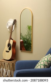 Living Room Interior With Mirror On Beige Wall. Stylish Accessories