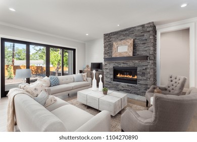 Living Room Interior In New Luxury Home With Fireplace And Hardwood Floors.