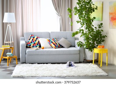 Living room interior with sofa, lamp and green tree