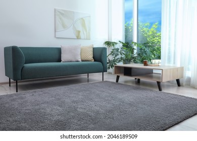 Living room interior with soft grey carpet and modern furniture