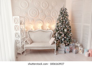 Living Room Interior With White Sofa Decorated Chic Christmas Tree, Gifts, Pillows. Xmas Interior With Fur-tree Decoration, White Wall. Christmas Decorated Interior With Presents And New Year Tree.