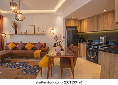Living room lounge area in luxury apartment show home showing interior design decor furnishing with kitchen - Shutterstock ID 2031333494