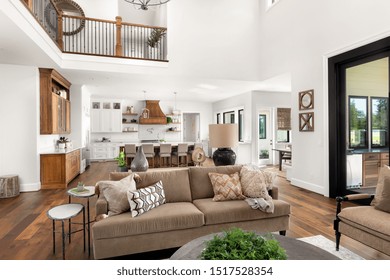 Living Room In Luxury Home With View Of Kitchen And Eating Nook. Large, Open Concept Floorplan Filled With Natural Light.