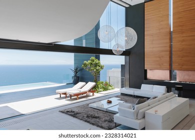 Living room and patio of modern house overlooking ocean