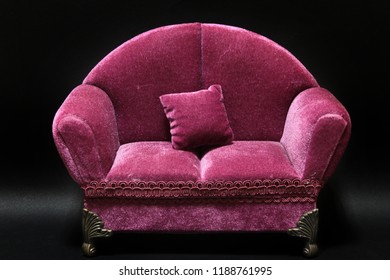 A Living Room Purple Velvet Couch On A Black Background.