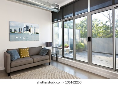 Living Room With Sliding Glass Door To Balcony