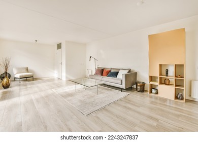 a living room with wood flooring and white walls, including a glass coffee table on the right hand side - Shutterstock ID 2243247837
