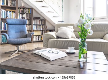 Living Room Wooden Table With White Roses, Coffee Cup And Book