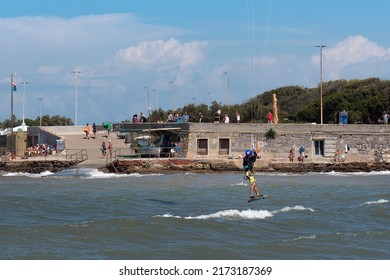 Livorno, Italy - August 2021: High Jump Of A Kitesurf In Slow Motion During A Windy Day.