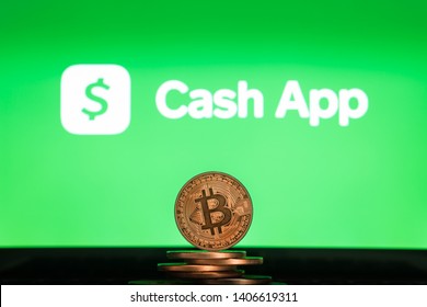 LJUBLJANA, SLOVENIA - 02.24.2019: Bitcoin On A Stack Of Coins With Cash App Logo On A Laptop Screen. Crypto And Blockchain Adoption. 