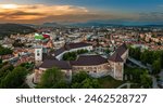 Ljubljana, Slovenia - Aerial panoramic view of Ljubljana castle on a summer afternoon with Franciscan Church of the Annunciation, Ljubljana Cathedral and skyline of the capital of Slovenia at sunset