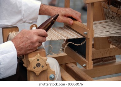 LJUBLJANA, SLOVENIA - AUGUST 28: Medieval fair in Ljubljana, Slovenia, on August 28, 2011.  Demonstration of various medieval crafts and way of life. Detail of hand weaving  on weaving loom.