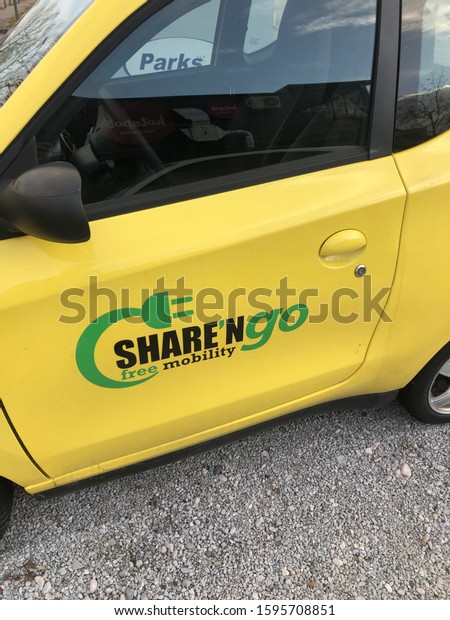 LJUBLJANA, SLOVENIA -\
DECEMBER 17, 2019: Share and go yellow electric car sharing vehicle\
side door with logo