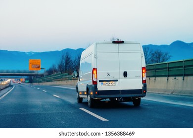 Ljubljana, Slovenia - January 14, 2019: White Minivan At Road. Mini Van Auto Vehicle On Driveway. European Van Transport Logistics Transportation. Auto With Driver