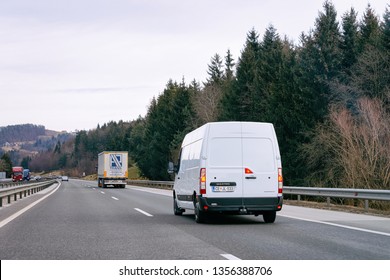 Ljubljana, Slovenia - January 16, 2019: White Minivan In Road. Mini Van Auto Vehicle On Driveway. European Van Transport Logistics Transportation. Auto