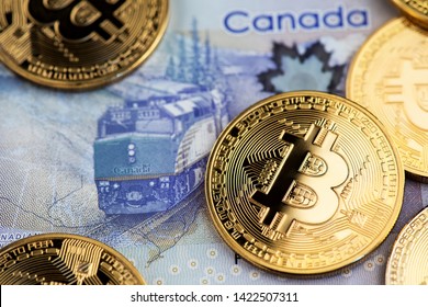 Ljubljana, Slovenia - June 12, 2019: Bitcoin Cryptocurrency Coins On Canadian Dollar Bill. Canada Bitcoin Cryptocurrency BTC CAD Money