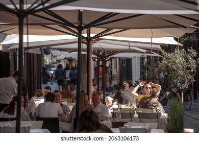 LJUBLJANA, SLOVENIA - JUNE 14, 2021: Packed Patio Of A Restaurant With People Sitting, Eating Out For Lunch Break At Noon, Not Respecting Social Distancing, In The City Center Of Ljubljana.

