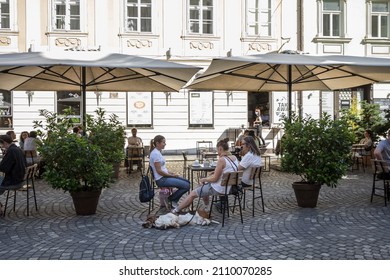 LJUBLJANA, SLOVENIA - JUNE 14, 2021: Selective Blur On A Patio Of A Pet Friendly Cafe Restaurant With People, Women And A Dog, Sitting, Respecting Social Distancing, In The City Center Of Ljubljana.

