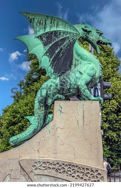 LJUBLJANA, SLOVENIA - JUNE 5, 2022: Dragon statue
on famous The Dragon Bridge (Zmajski most). Built between 1900 and
1901, designed by architect Jurij Zaninović. One of the symbols of
the city.