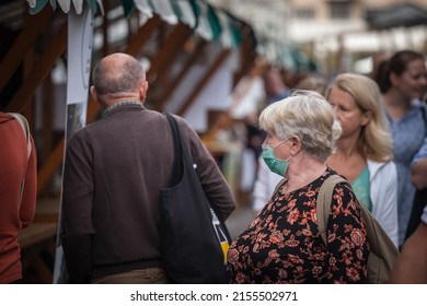 LJUBLJANA, SLOVENIA - SEPTEMBER 18, 2021: Selective Blur On Old Woman In A Middle Of A Crowd, Wearing A Facemask, Waking  In Street Of Ljubljana During Coronavirus Covid 19  Crisis.



