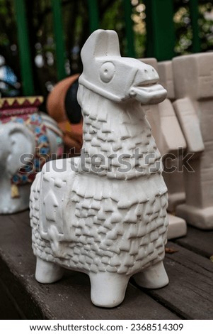 The llama from Fortnite. Clay (plaster) white unpainted figurine of a alpaca (pinata) from the video game Fortnite