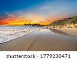 Llandudno sandy Beach at sunset  with rocks and mountain in Cape Town South Africa